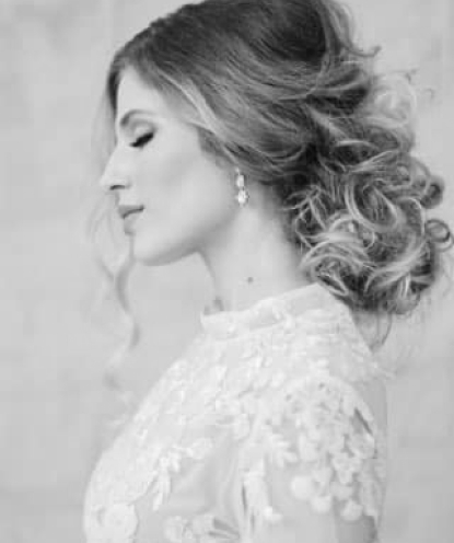 Faded background image of a girl with her eyes closed in a wedding dress and earrings.